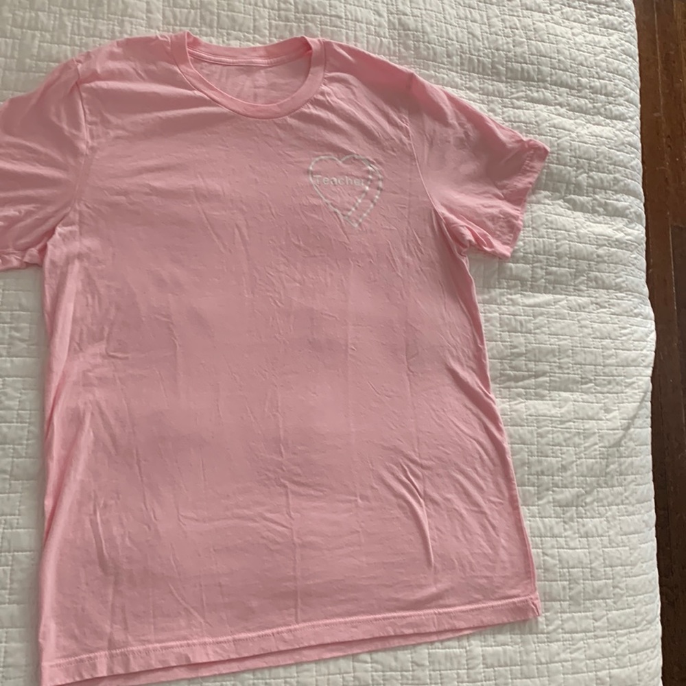 T-shirt with “teacher” in hearts on front.